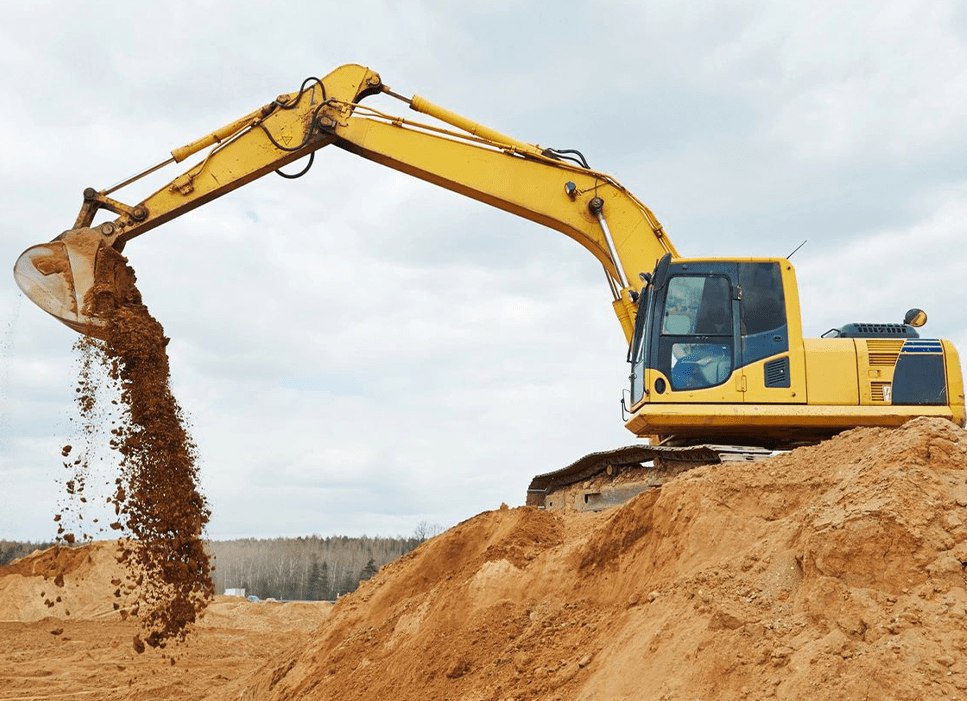 A yellow excavator is digging in the dirt.