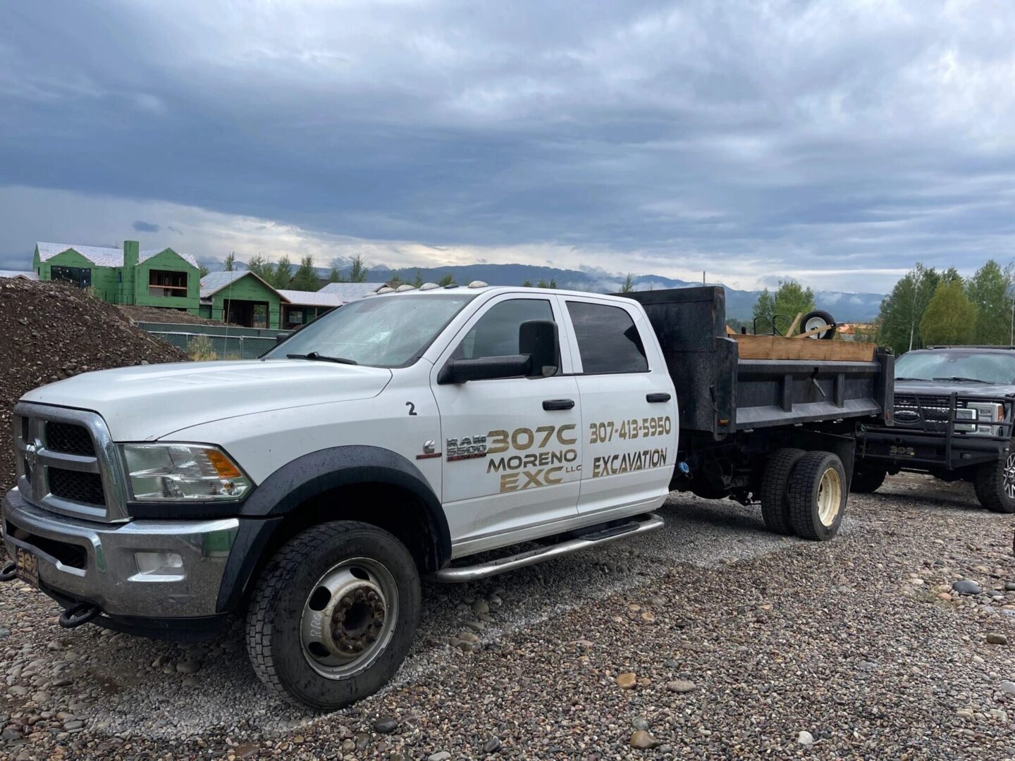 A white truck with some trees in the background