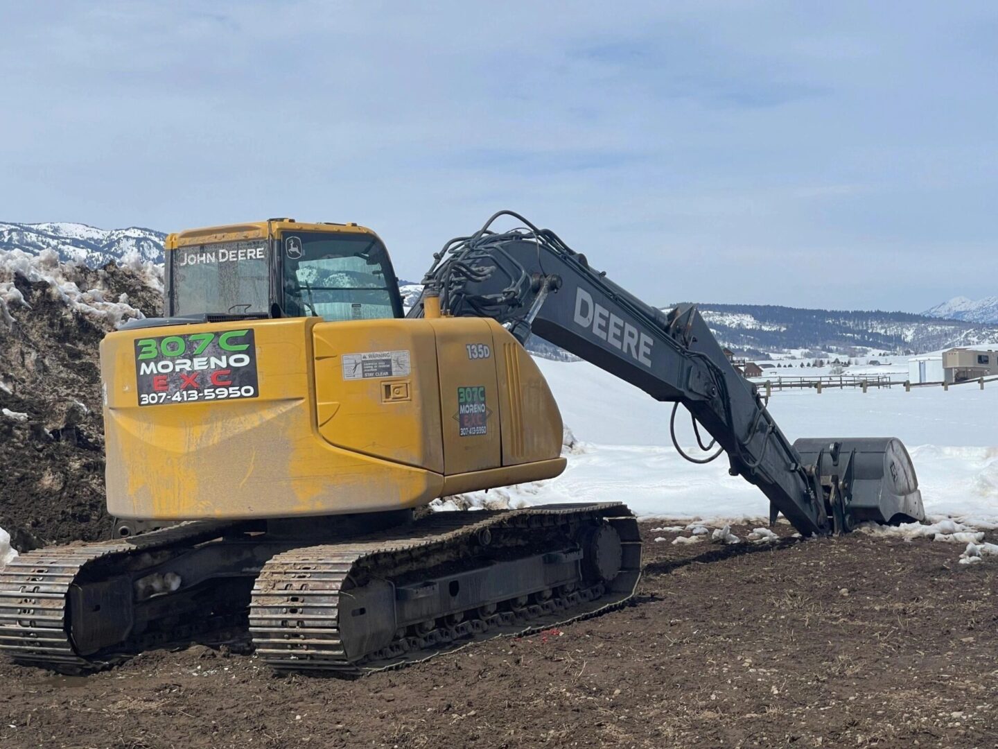 A yellow and black excavator is on the ground