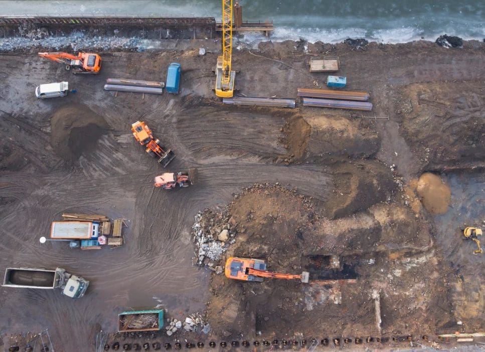 A construction site with many vehicles and equipment.