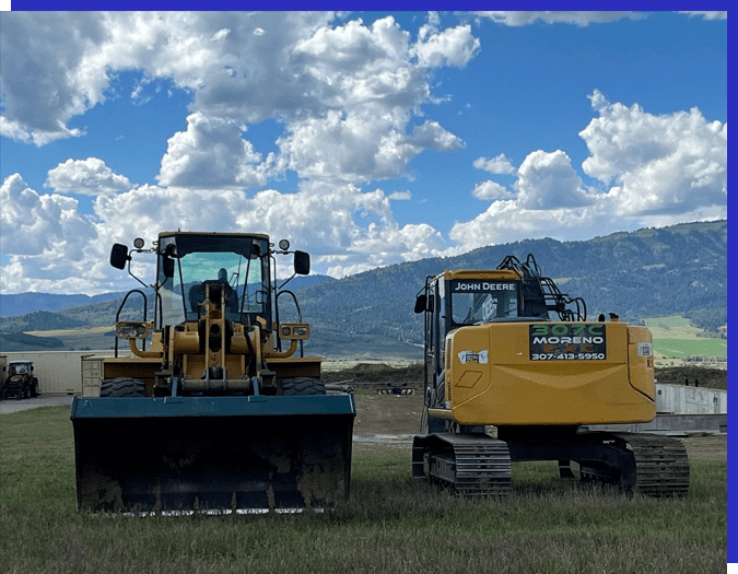 A yellow and black tractor in the grass